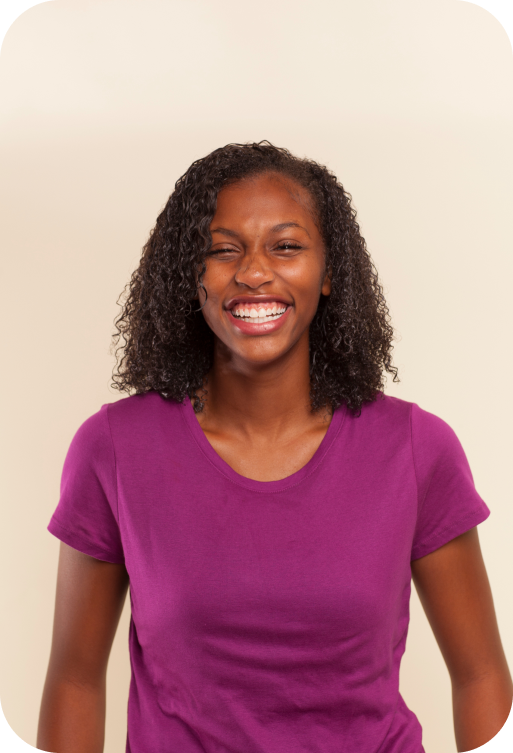 Patient with curly hair and a fantastic smile after being treated at Sheffield & Le Orthodontics