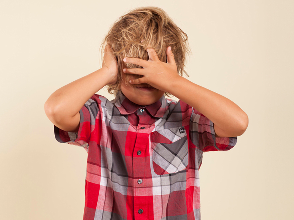 child covering his face