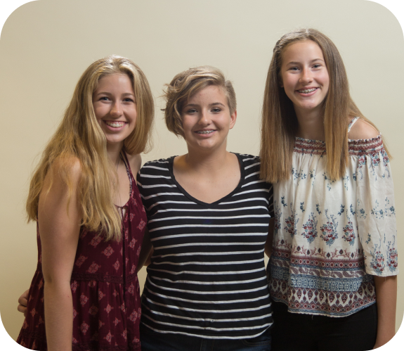 three smiling Sheffield and Le Orthodontics patients