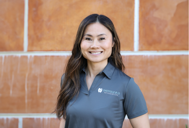 Orthodontist In Brentwood, Ca, Dr. Le Smiling In Her Gray Sheffield & Le Polo