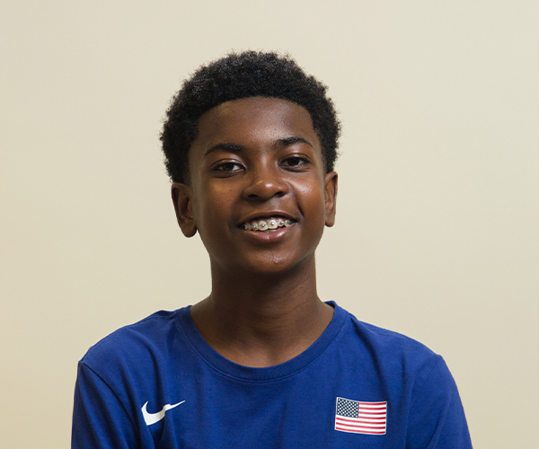Smiling child undergoing early orthodontic treatment with braces for kids