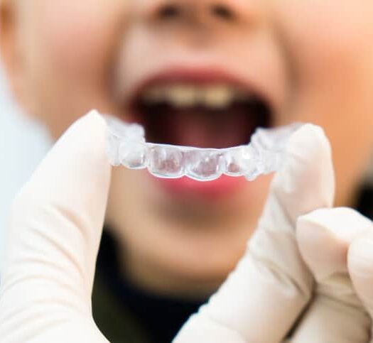A Boy Receiving Early Treatment With Clear Aligners At Doctors Office