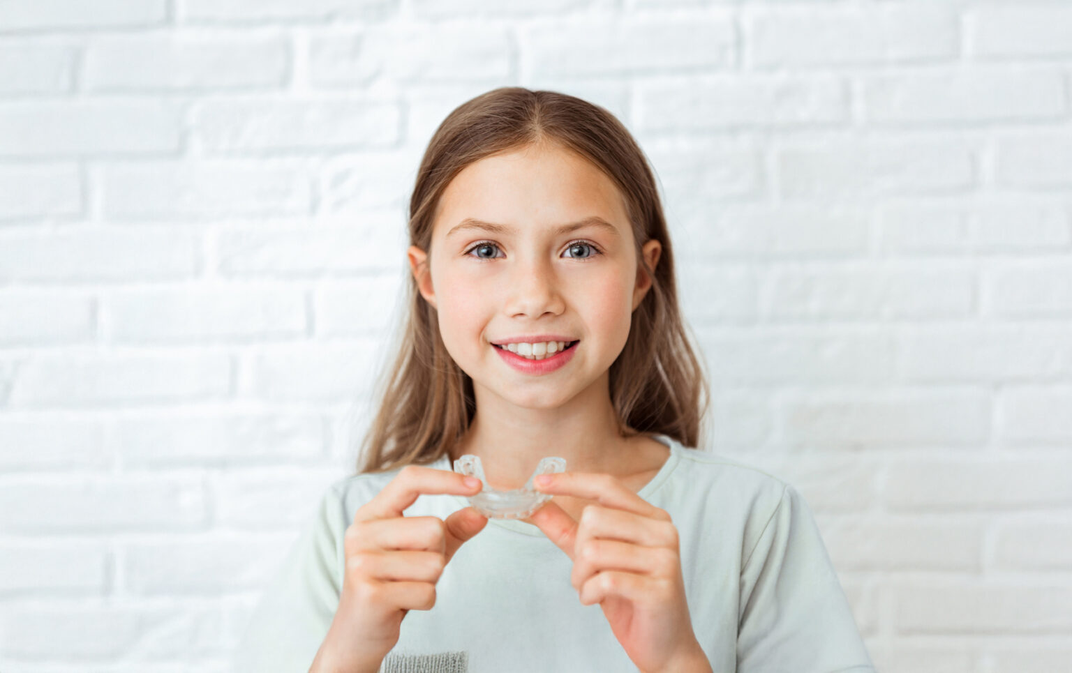 A Portrait Of A Little Girl With Clear Aligner
